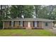 Charming single-story brick home featuring classic shutters and a well-maintained front yard at 679 Winchester Ln, Norcross, GA 30071