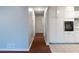 Bright kitchen featuring white cabinets and modern built-in appliances, with a view of the hallway at 679 Winchester Ln, Norcross, GA 30071