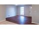 Cozy living room with large window providing ample natural light and hardwood flooring near front door at 679 Winchester Ln, Norcross, GA 30071
