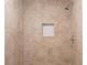 Shower with tan tiled walls and white hexagon tile in the niche at 679 Winchester Ln, Norcross, GA 30071