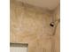 Corner of a tiled shower with gray shower head and white hexagon-tiled niche at 679 Winchester Ln, Norcross, GA 30071