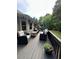 Outdoor deck with patio furniture and lush greenery for outdoor enjoyment at 1305 Lake Forest Ln, Mcdonough, GA 30253