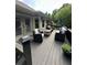 A spacious back deck with outdoor seating offers views of the surrounding greenery at 1305 Lake Forest Ln, Mcdonough, GA 30253