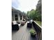 Relaxing back deck features comfortable seating and a serene view of the surrounding trees at 1305 Lake Forest Ln, Mcdonough, GA 30253