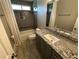 Bathroom features tiled walls, granite counters, and modern fixtures at 1305 Lake Forest Ln, Mcdonough, GA 30253