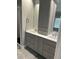 Bathroom featuring double sinks with quartz countertops, gray cabinetry, and modern fixtures at 1305 Lake Forest Ln, Mcdonough, GA 30253
