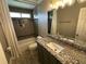 Bathroom features tiled walls, granite counters, and modern fixtures at 1305 Lake Forest Ln, Mcdonough, GA 30253