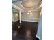 Open dining area featuring dark wood floors and modern chandelier at 1305 Lake Forest Ln, Mcdonough, GA 30253