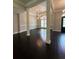 Elegant dining room with natural light, dark hardwood flooring, and decorative columns creating an inviting space at 1305 Lake Forest Ln, Mcdonough, GA 30253