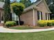 Well-maintained brick home with lush lawn, mature trees, and attractive landscaping at 1305 Lake Forest Ln, Mcdonough, GA 30253
