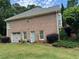 Brick home with well-maintained landscaping and an attached garage at 1305 Lake Forest Ln, Mcdonough, GA 30253