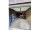 Unfinished garage space, with shelving, workbench, and insulation at 1305 Lake Forest Ln, Mcdonough, GA 30253