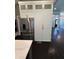 Kitchen featuring a stainless steel fridge with white cabinets and dark floors at 1305 Lake Forest Ln, Mcdonough, GA 30253