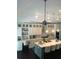 Open kitchen with island seating, pendant lights, desk area, and modern appliances at 1305 Lake Forest Ln, Mcdonough, GA 30253