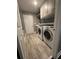 Efficient laundry room with washer, dryer, storage cabinets and a tile floor for easy cleaning at 1305 Lake Forest Ln, Mcdonough, GA 30253