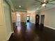 Living room with hardwood floors, ceiling fan, and open layout to dining and kitchen at 1305 Lake Forest Ln, Mcdonough, GA 30253