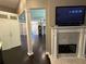 Inviting living room featuring a fireplace, dark wood floors, and an open floor plan at 1305 Lake Forest Ln, Mcdonough, GA 30253
