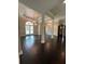 Open floorplan living room featuring dark hardwood floors and decorative stained glass at 1305 Lake Forest Ln, Mcdonough, GA 30253