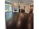 Open living room with fireplace, hardwood floors, and seamless flow to the kitchen at 1305 Lake Forest Ln, Mcdonough, GA 30253