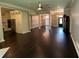 Spacious living area with hardwood floors, ceiling fan, and open layout to kitchen at 1305 Lake Forest Ln, Mcdonough, GA 30253