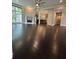 Open-concept living area featuring dark hardwood floors, fireplace, ceiling fan, and abundant natural light at 1305 Lake Forest Ln, Mcdonough, GA 30253
