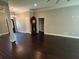 Large living area featuring dark wood floors, neutral paint, and an open entryway at 1305 Lake Forest Ln, Mcdonough, GA 30253