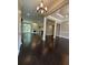 Bright living room featuring a fireplace, hardwood floors, and a modern light fixture at 1305 Lake Forest Ln, Mcdonough, GA 30253