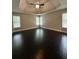 Spacious main bedroom features a trey ceiling and hardwood floors at 1305 Lake Forest Ln, Mcdonough, GA 30253