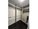 A walk-in closet is shown, featuring built-in shelving and ample storage space at 1305 Lake Forest Ln, Mcdonough, GA 30253