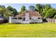 Spacious backyard showcasing the home's deck, screened porch, and lush green lawn, ideal for entertaining at 1480 Shady Cove Ln, Lawrenceville, GA 30043