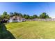 Large, fenced backyard with green grass and a view of the house's deck and patio, offering ample space at 1480 Shady Cove Ln, Lawrenceville, GA 30043