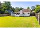 The backyard features a well-maintained lawn, a spacious deck, and mature trees, creating a serene outdoor space at 1480 Shady Cove Ln, Lawrenceville, GA 30043