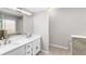 Bathroom with double sink vanity, white countertop, modern cabinets, and large mirror at 1480 Shady Cove Ln, Lawrenceville, GA 30043