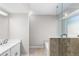 Bright bathroom featuring a marble shower, soaking tub, and modern vanity with white cabinets at 1480 Shady Cove Ln, Lawrenceville, GA 30043