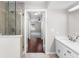 Bathroom featuring a glass shower, double sink vanity, and entrance to the bedroom at 1480 Shady Cove Ln, Lawrenceville, GA 30043