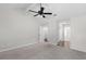 Bedroom with carpeting and a ceiling fan leading to a closet with built-in shelving at 1480 Shady Cove Ln, Lawrenceville, GA 30043