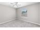 Carpeted bedroom featuring a ceiling fan and a window with natural light at 1480 Shady Cove Ln, Lawrenceville, GA 30043