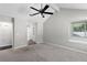 Bedroom featuring carpeting, a ceiling fan, and a closet with built-in shelving at 1480 Shady Cove Ln, Lawrenceville, GA 30043