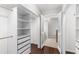 Spacious walk-in closet with built-in shelving units and access to the bathroom at 1480 Shady Cove Ln, Lawrenceville, GA 30043