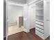 Walk-in closet with built-in shelving units and a view into the bathroom at 1480 Shady Cove Ln, Lawrenceville, GA 30043