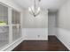 Dining area with wood floors, chandelier, wainscoting, and large window at 1480 Shady Cove Ln, Lawrenceville, GA 30043