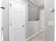 Hallway with white doors, smart thermostat, and neutral carpet at 1480 Shady Cove Ln, Lawrenceville, GA 30043