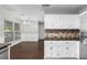 Spacious kitchen with stainless steel appliances, granite counters, wood floors, and adjacent dining area at 1480 Shady Cove Ln, Lawrenceville, GA 30043