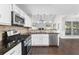 Modern kitchen with stainless steel appliances, granite countertops, and backsplash at 1480 Shady Cove Ln, Lawrenceville, GA 30043