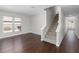 Bright living room with hardwood floors, large window, and staircase at 1480 Shady Cove Ln, Lawrenceville, GA 30043