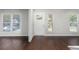 Spacious living room with hardwood floors, a white front door, and bright natural light at 1480 Shady Cove Ln, Lawrenceville, GA 30043