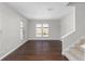Open-concept room with hardwood floors, staircase, and neutral paint at 1480 Shady Cove Ln, Lawrenceville, GA 30043