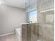 Bathroom with large glass shower featuring marble-style tile and soaking tub at 1480 Shady Cove Ln, Lawrenceville, GA 30043