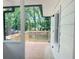 Back porch featuring stained wood floor and railing with view into a wooded lot at 1599 Sandtown Rd, Atlanta, GA 30311