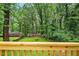 Inviting backyard with views of mature trees from a wooden deck with railing at 1599 Sandtown Rd, Atlanta, GA 30311